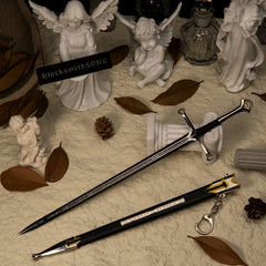Andúril replica (30cm die-cast zinc alloy sword) — drawn beside its scabbard in a stone-angel diorama, by BlacksmithSONG.