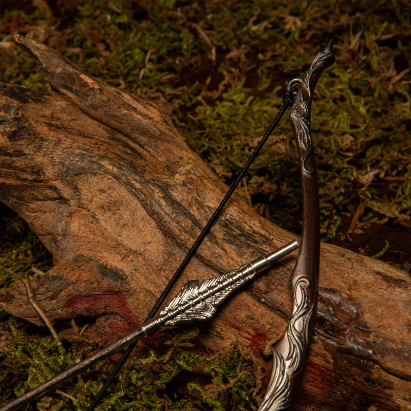 Bow of the Galadhrim replica — close-up of the carved bow grip and arrowhead on weathered wood.