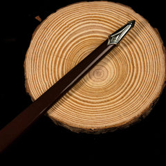 Galadriel Sword replica — blade tip with fine fuller lines, close-up on a wood slice.