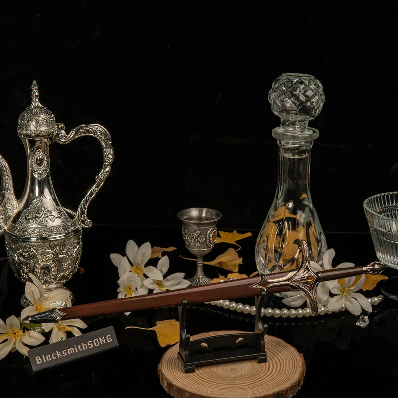 Galadriel Sword replica — set on the small display stand among the pearls and blossoms.