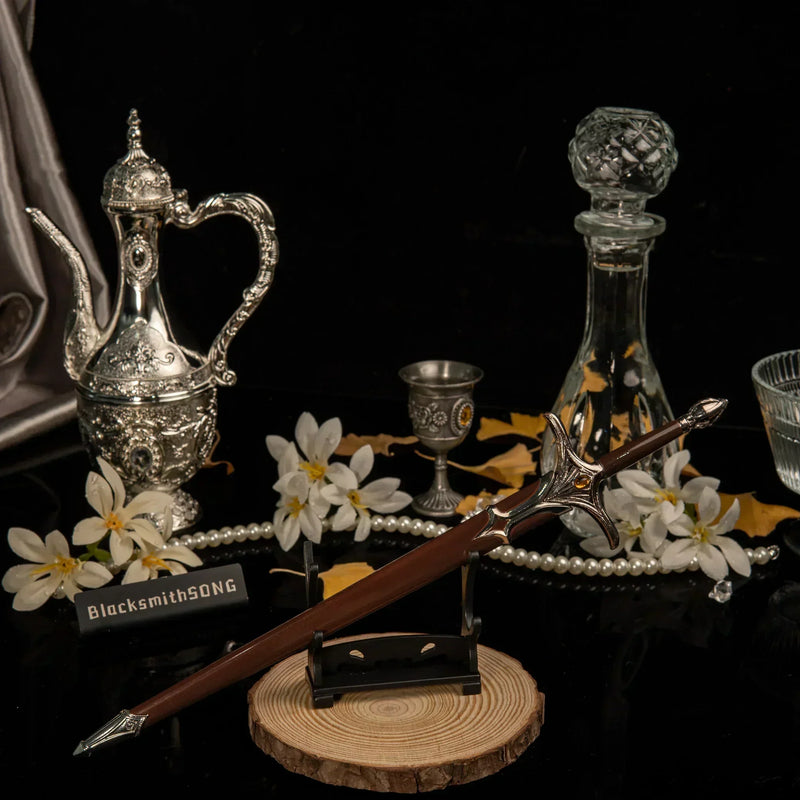 Galadriel Sword replica — angled view on the small display stand beside the crystal decanter.