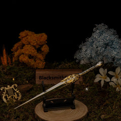 Galadriel's Dagger replica — set on the small display stand against the mossy backdrop.