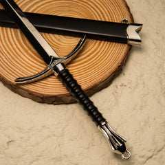 Glamdring replica — swept crossguard, ribbed grip and fanned pommel on a wood slice.