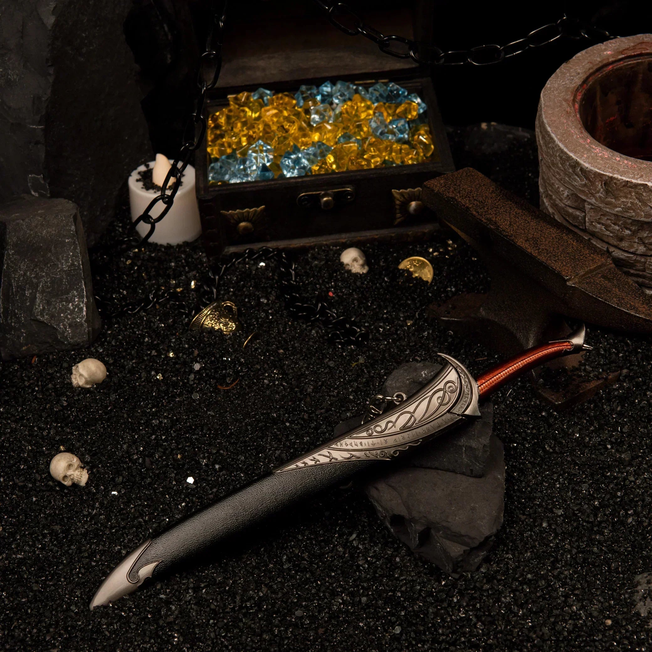 Full view of the sheathed Orcrist metal replica resting in the dark, treasure-themed diorama.