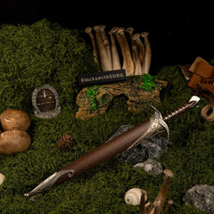 Sting replica — wider view of the handcrafted green hollow with a round door and tall mushrooms.