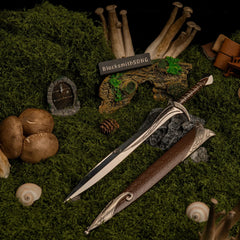 Sting replica (30cm die-cast zinc alloy blade) — drawn beside its scabbard in a mossy hollow set, by BlacksmithSONG.