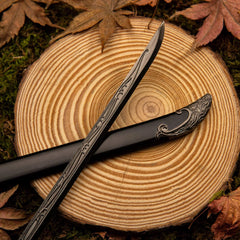 Thranduil's Sword replica — engraved vine-pattern blade crossed over the black scabbard.
