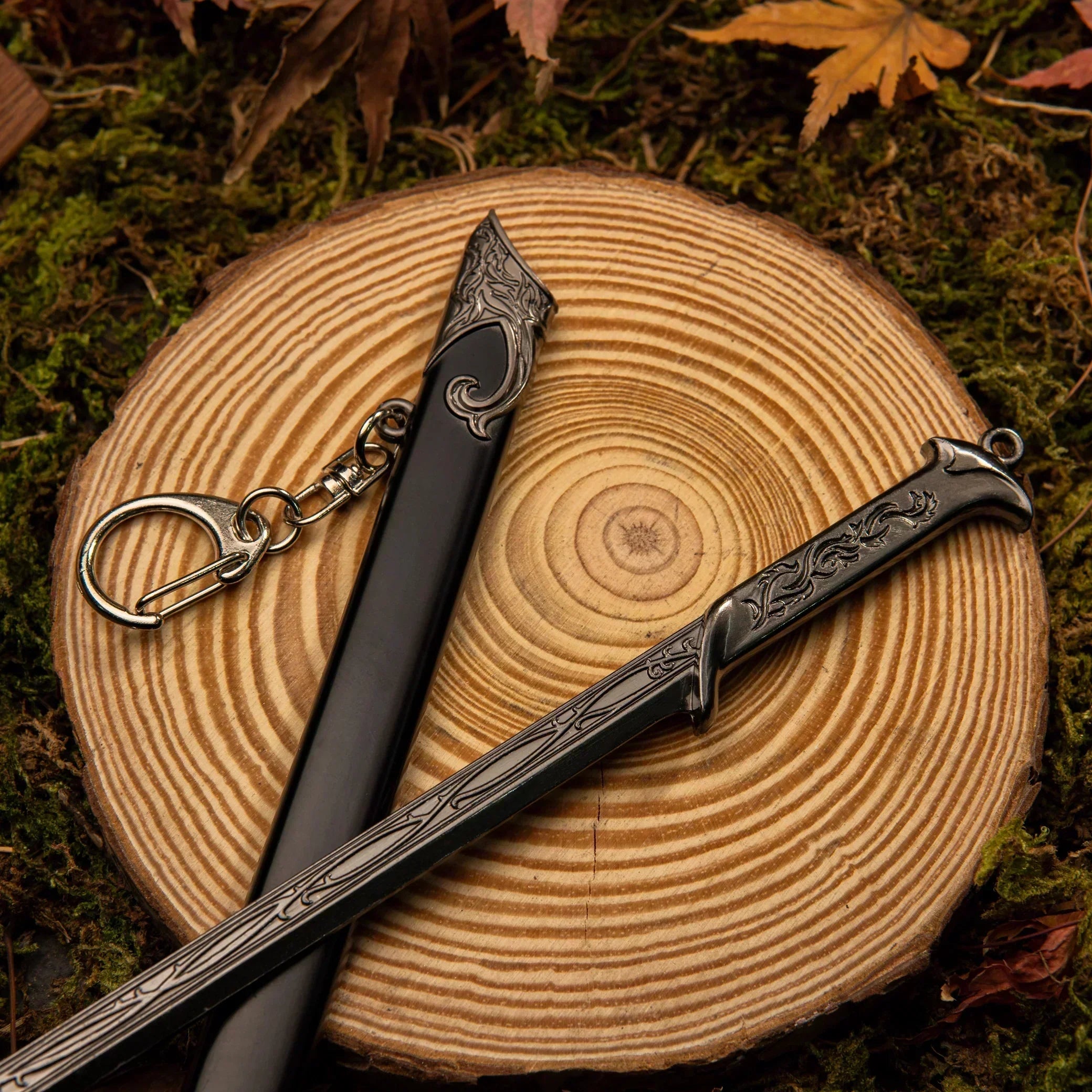 Close-up of Thranduil's Sword hilt resting on a wooden slice, showing the sleek silver handle.