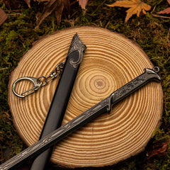 Thranduil's Sword replica — antler-curled crossguard and wrapped grip on a wood slice, keyring detail visible at the pommel.