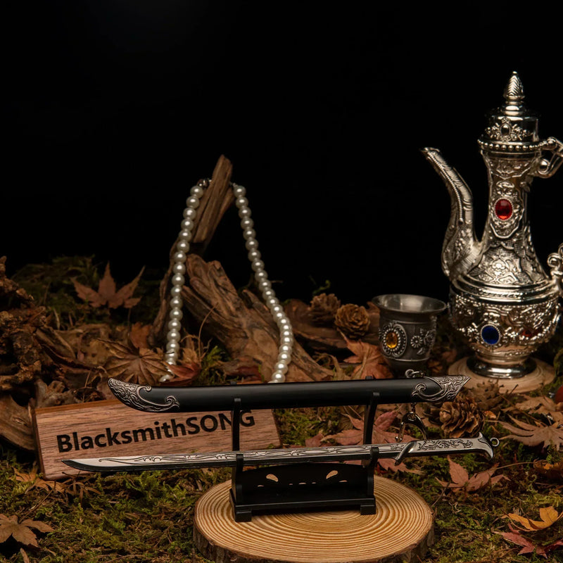Thranduil's Sword replica — angled view on the small display stand beside the pearl strand.