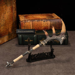 Fatalis Zaggespanon replica — on the Large Display Stand beside stacked books.