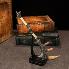 Fatalis Zaggespanon replica — on the Vertical Display Stand beside stacked books.