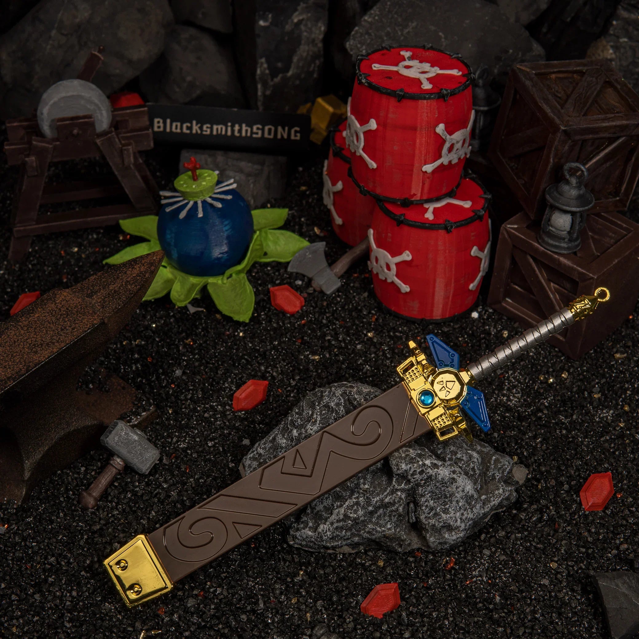 Front view of the heavy 134g Zelda Biggoron's Sword collectible prop resting horizontally on dark gravel terrain amidst a Goron workshop display.