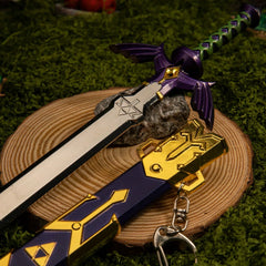 Master Sword replica — wing-shaped hilt guard detail in a mossy forest setting.