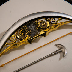 Close-up macro shot of the Zelda Bow of Light replica, highlighting the intricate hollowed-out golden scrollwork framed by the sleek silver outer rim.