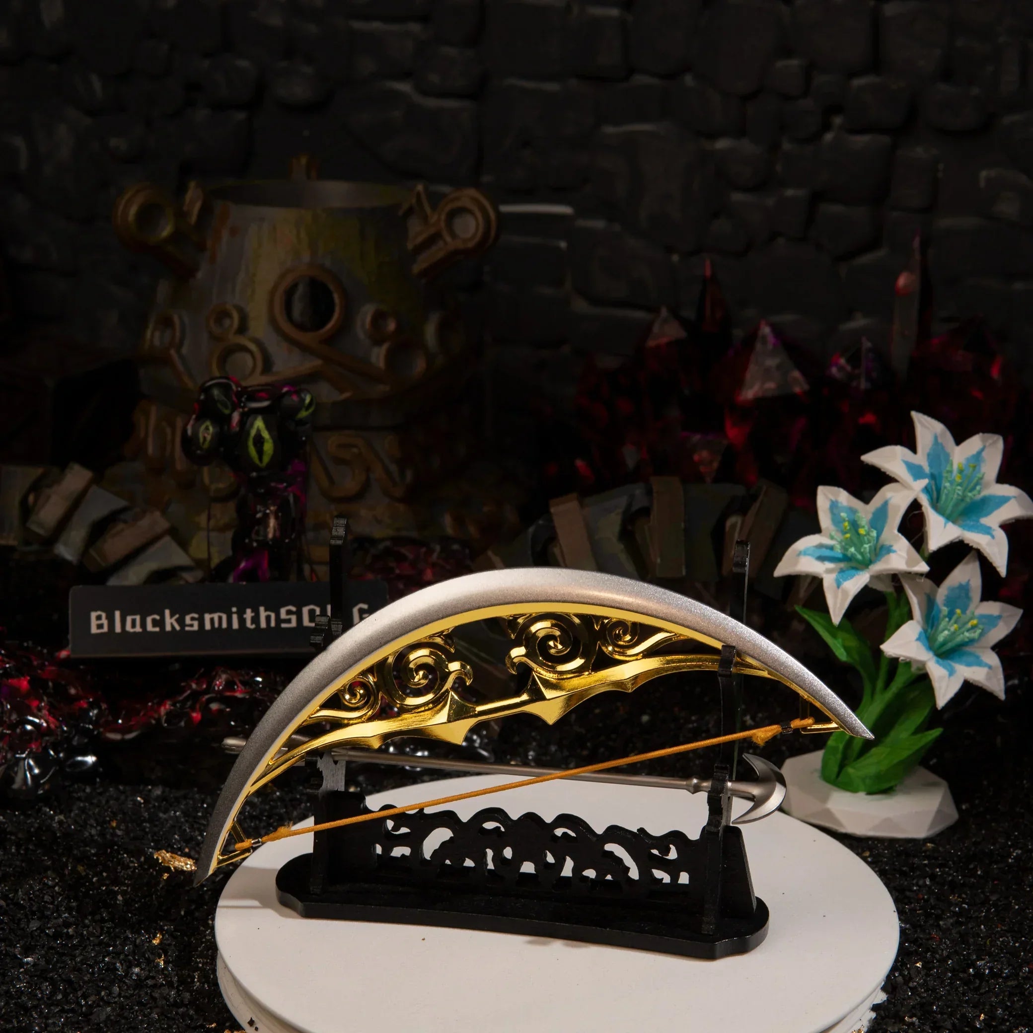The Zelda Bow of Light miniature and Light Arrow displayed horizontally on a large black rack, set in front of the terrifying multi-eyed Calamity Ganon Malice diorama.