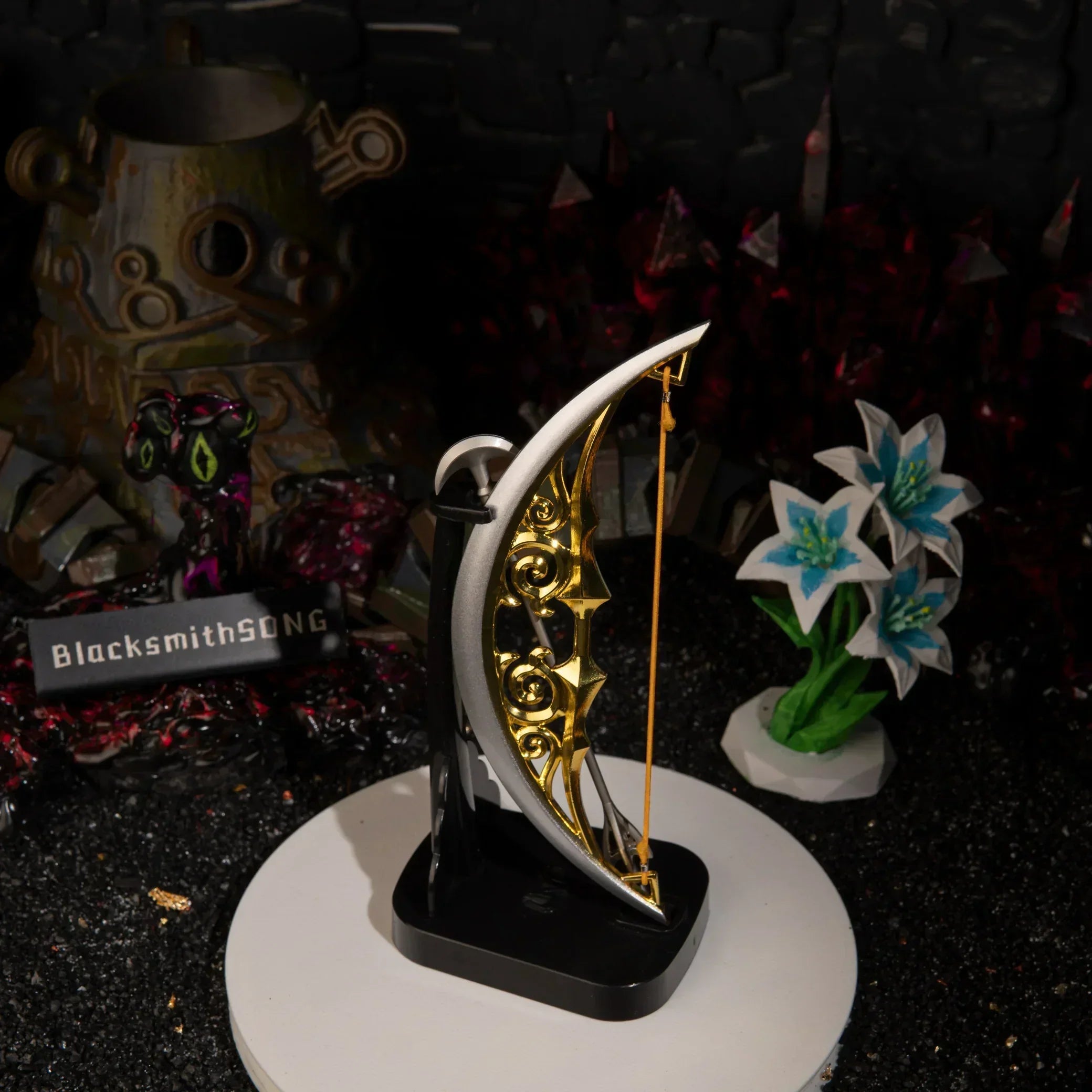 An upright vertical display of the 15cm metal Zelda Bow of Light on a black base, standing tall and catching the light in a miniature Hyrule final boss setting.