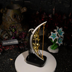 An upright vertical display of the 15cm metal Zelda Bow of Light on a black base, standing tall and catching the light in a miniature Hyrule final boss setting.