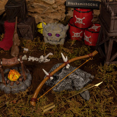 Dragon Bone Boko Bow replica (17.5cm die-cast zinc alloy bow) — resting on a rock in a handcrafted outpost diorama, by BlacksmithSONG.