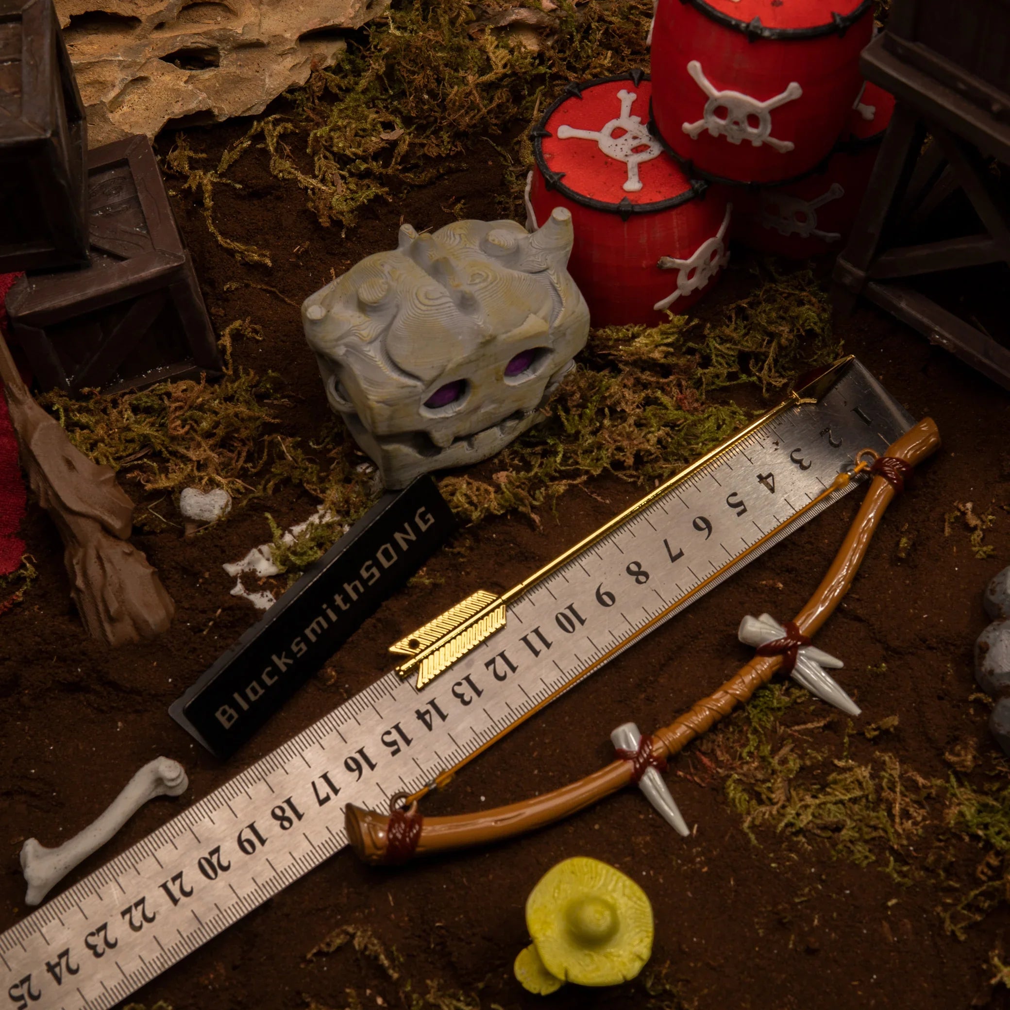 Dragon Bone Boko Bow metal replica measured against a ruler, confirming its 17.5cm length next to a monster skull chest.