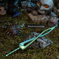 Fierce Deity Sword replica (21cm die-cast zinc alloy sword) — resting on stone in a handcrafted moonlit clearing, by BlacksmithSONG.