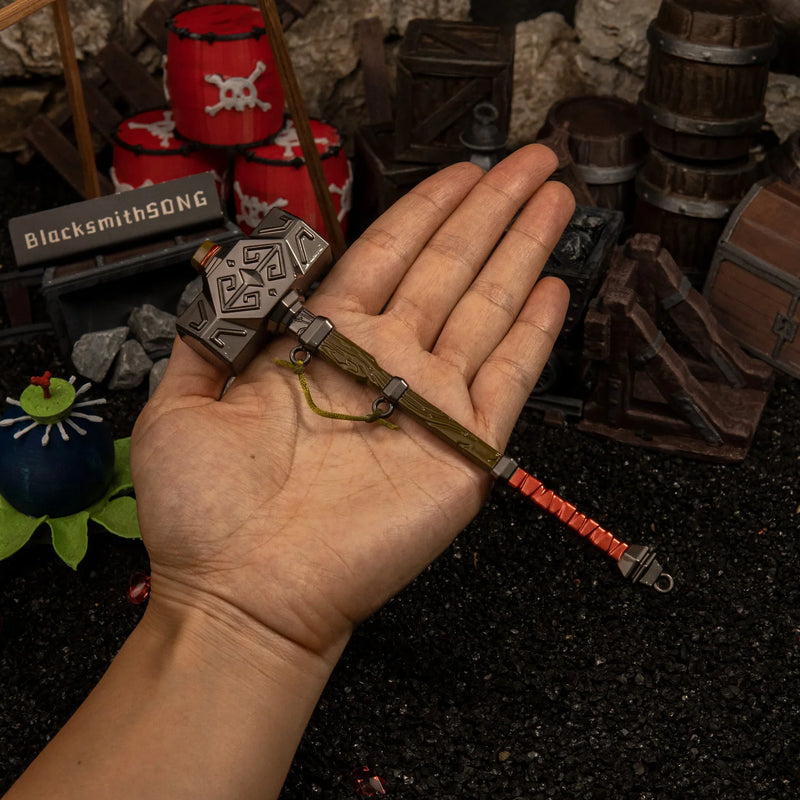 Iron Sledgehammer replica (17.5cm die-cast zinc alloy hammer) — held in hand for scale.