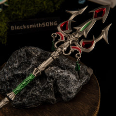 Lightscale Trident replica — forked head and red tine accents close-up on a stone base.