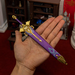 Royal Broadsword replica (21cm die-cast zinc alloy sword) — held in hand for scale.
