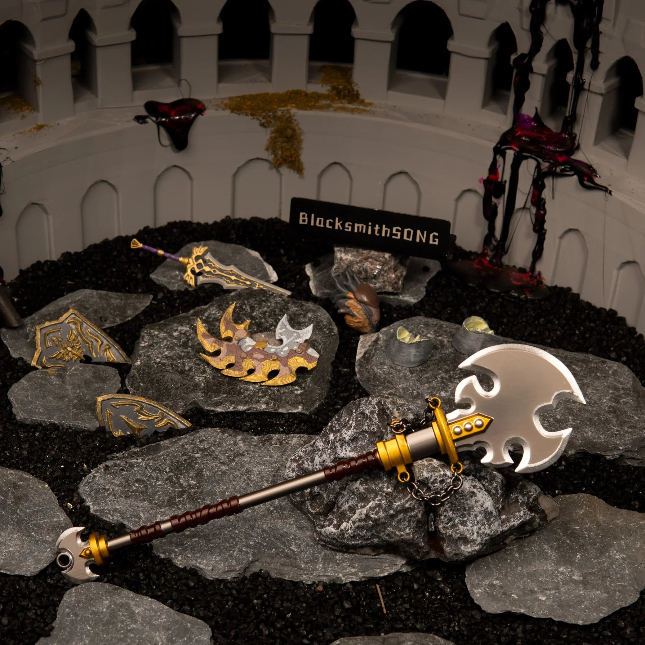 Savage Lynel Spear replica displayed in an arena diorama, surrounded by a Lynel Hoof, shattered shield, and Ganon's Malice.