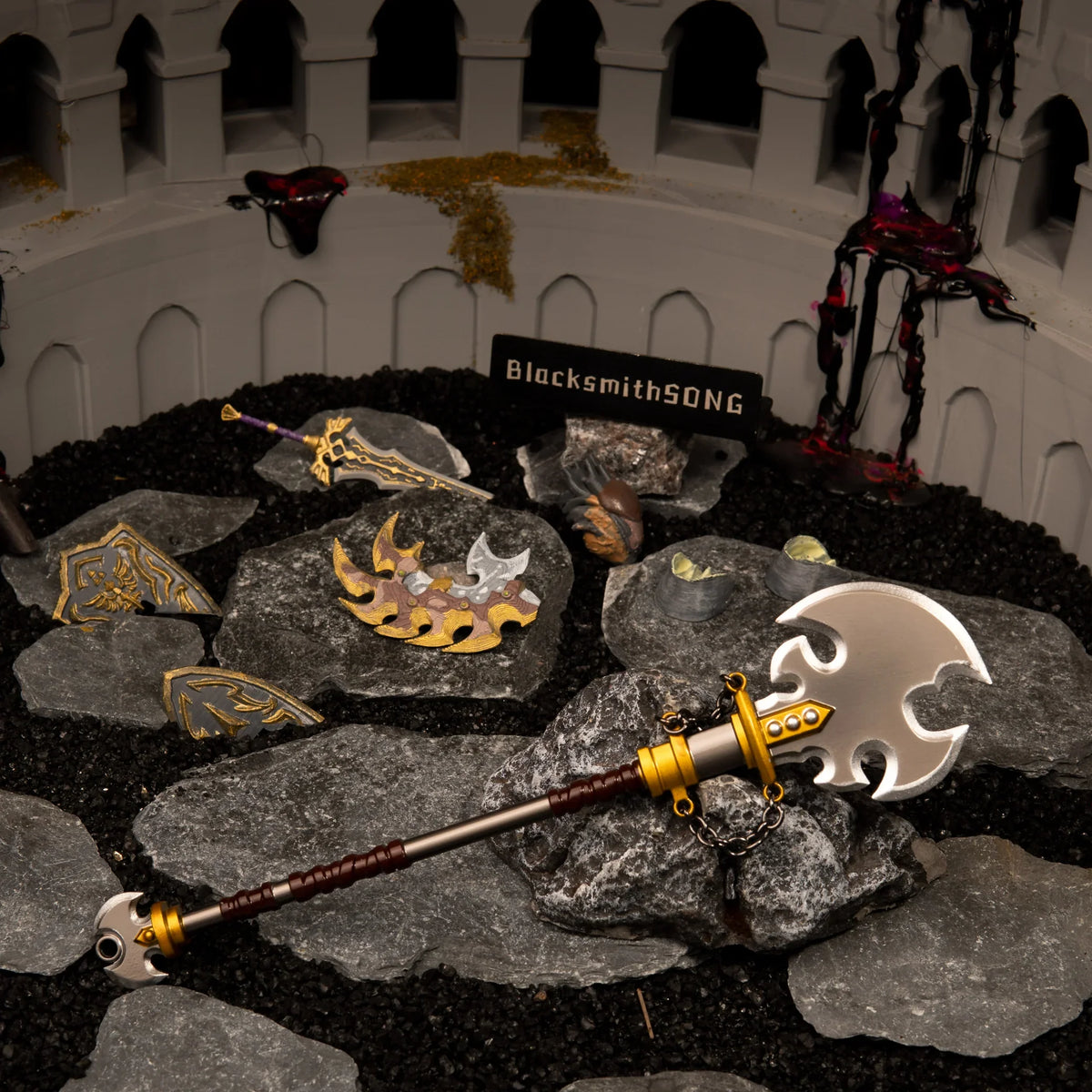 Savage Lynel Spear replica displayed in an arena diorama, surrounded by a Lynel Hoof, shattered shield, and Ganon's Malice.