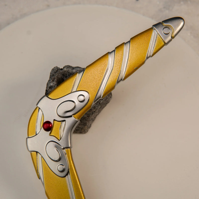 Sea-Breeze Boomerang replica — hinge and red gem accent close-up on a pale surface.