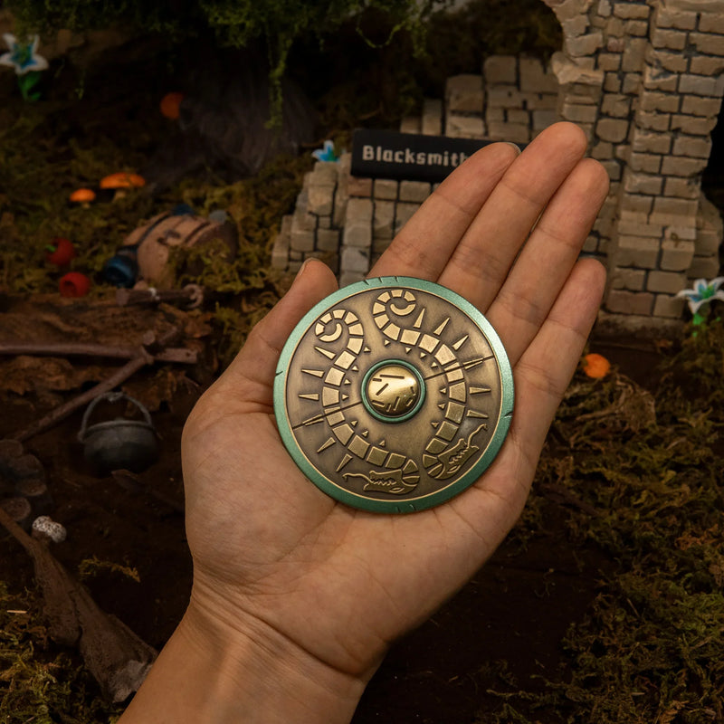 Traveler's Shield replica (7cm die-cast zinc alloy shield) — held in hand for scale.