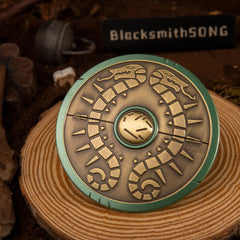 Traveler's Shield replica — reverse side showing the cast grip bar, resting on a wood-ring stand.