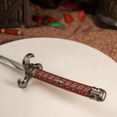 Windcleaver replica — hooked hilt and wave-patterned blade close-up.