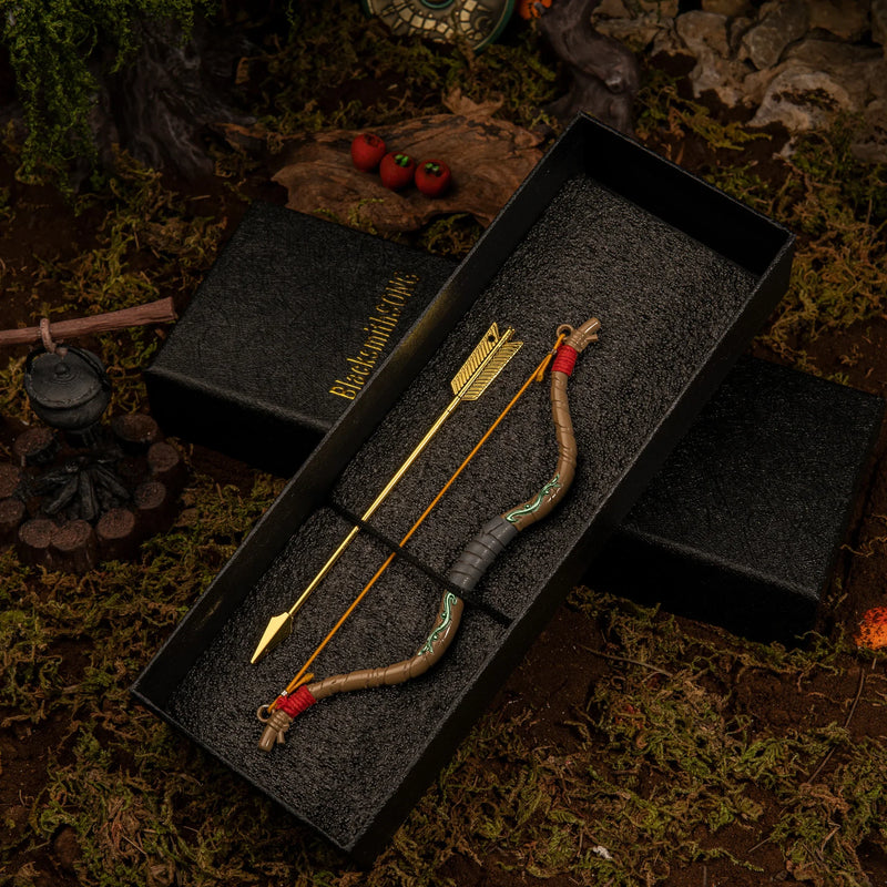 A 18cm solid metal Zelda Wooden Bow replica and its matching golden arrow, elegantly displayed inside a premium black foam-lined gift box.