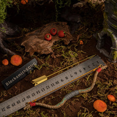 A measuring ruler placed alongside the metal Zelda Wooden Bow and golden arrow, verifying its 18 centimeter length for 1/6 scale action figure photography.